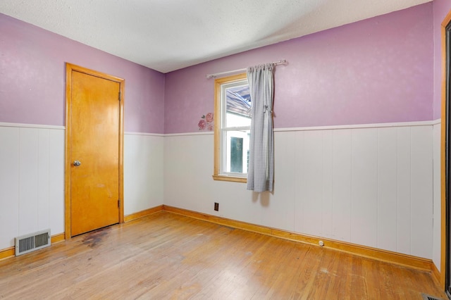 empty room with light hardwood / wood-style flooring