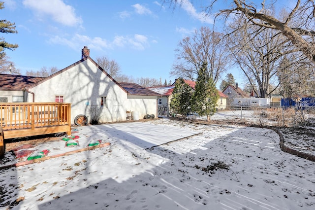 yard layered in snow featuring a wooden deck