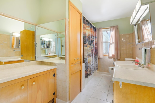 full bathroom with tile patterned floors, toilet, a shower with shower curtain, tile walls, and vanity