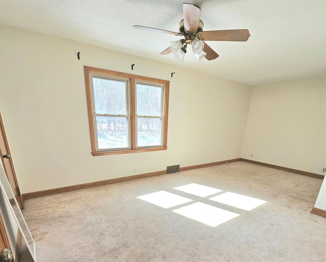 carpeted empty room featuring visible vents, baseboards, and a textured ceiling