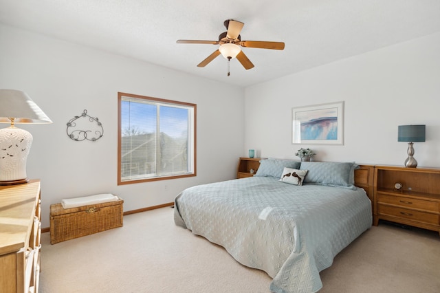 carpeted bedroom featuring baseboards and a ceiling fan