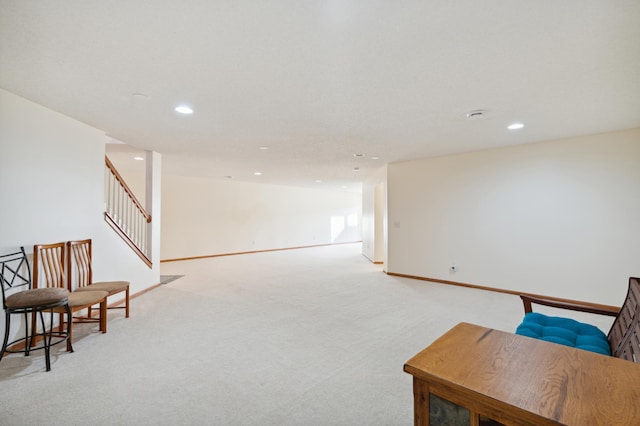 sitting room featuring light carpet, stairway, baseboards, and recessed lighting