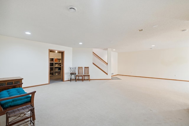 sitting room with stairs, carpet, recessed lighting, and baseboards