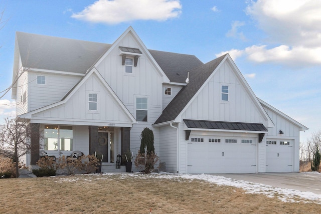 modern inspired farmhouse with a porch and a garage