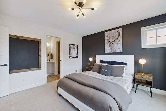 carpeted bedroom featuring ensuite bathroom