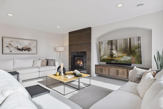 carpeted living room with a fireplace