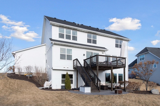 back of property featuring an outdoor living space, a deck, a patio, and a lawn