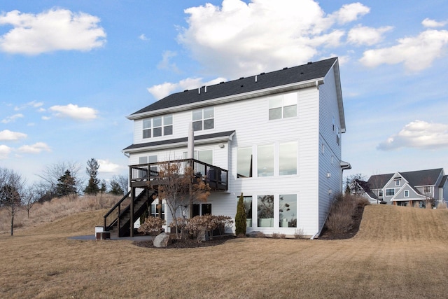 rear view of property featuring a wooden deck and a yard