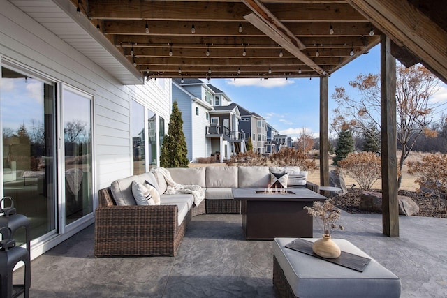 view of patio with an outdoor living space with a fire pit