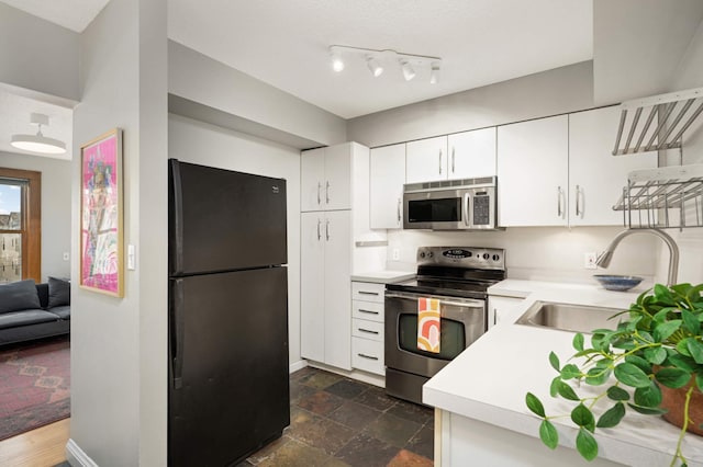 kitchen featuring white cabinetry, stainless steel appliances, and sink