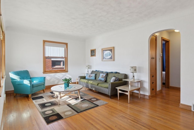 living room with hardwood / wood-style floors and a textured ceiling