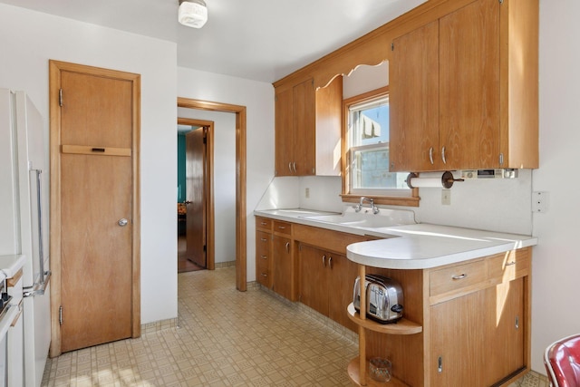 kitchen featuring high end white refrigerator and sink