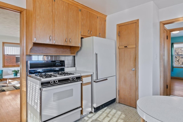 kitchen featuring white appliances and backsplash