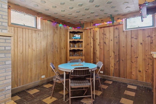 dining space featuring wooden walls