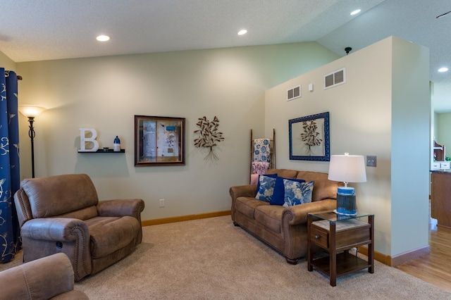 living room featuring vaulted ceiling and light colored carpet