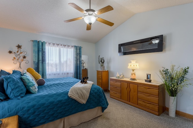 bedroom with lofted ceiling, light colored carpet, a textured ceiling, and ceiling fan