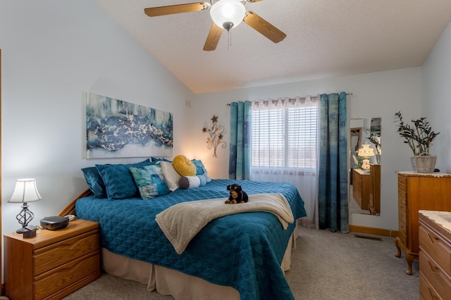 carpeted bedroom featuring lofted ceiling, a textured ceiling, and ceiling fan