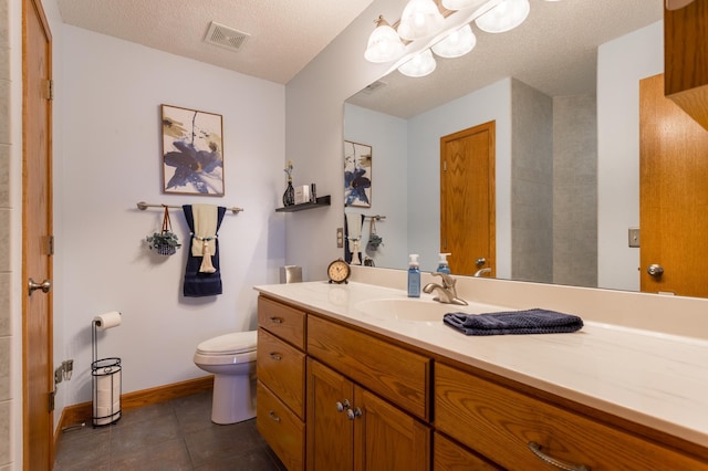 bathroom featuring tile patterned flooring, vanity, a textured ceiling, toilet, and a chandelier