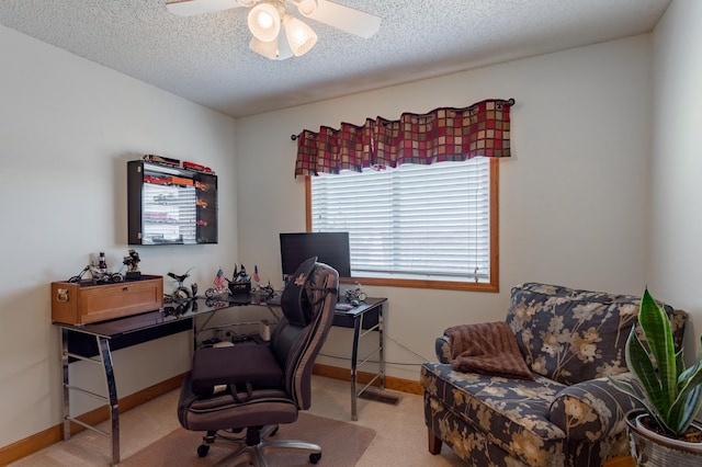 carpeted home office featuring ceiling fan and a textured ceiling