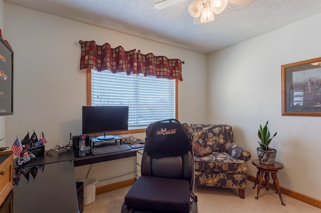 carpeted home office featuring ceiling fan and a textured ceiling