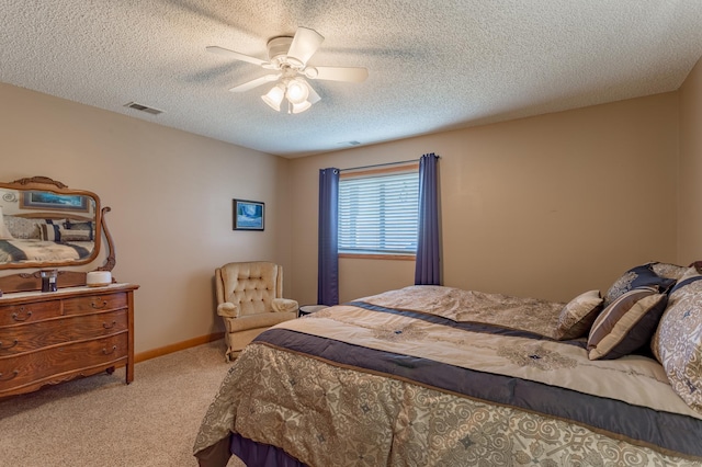 bedroom featuring light carpet, a textured ceiling, and ceiling fan