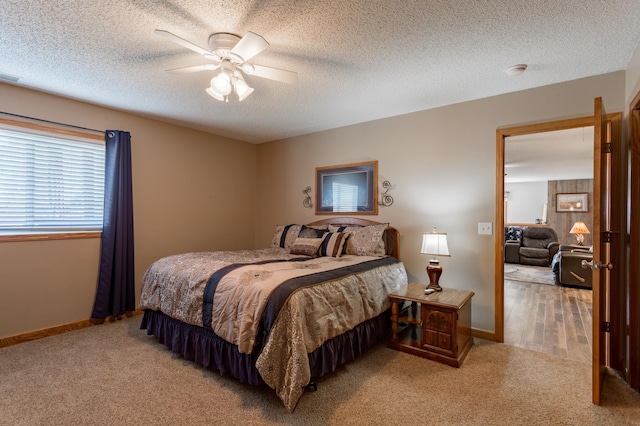 carpeted bedroom with a textured ceiling and ceiling fan