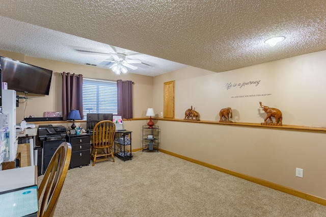 carpeted home office with ceiling fan and a textured ceiling