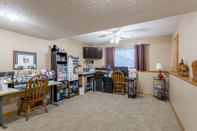 carpeted home office featuring ceiling fan and a textured ceiling