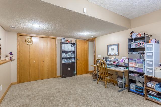 home office featuring carpet and a textured ceiling