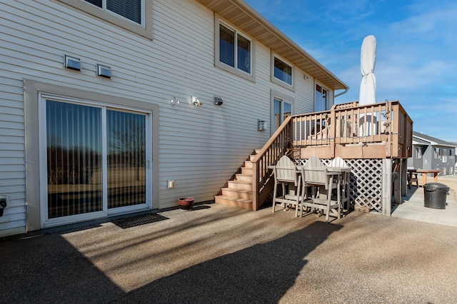 back of property featuring a patio area and a deck