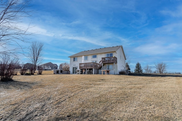 back of property with a lawn and a deck