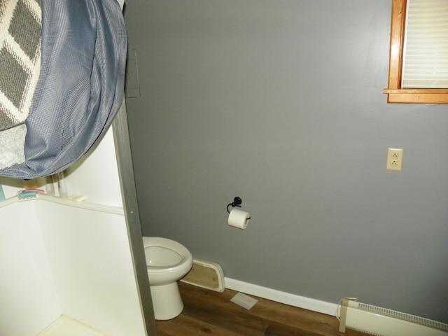 bathroom with toilet and hardwood / wood-style floors