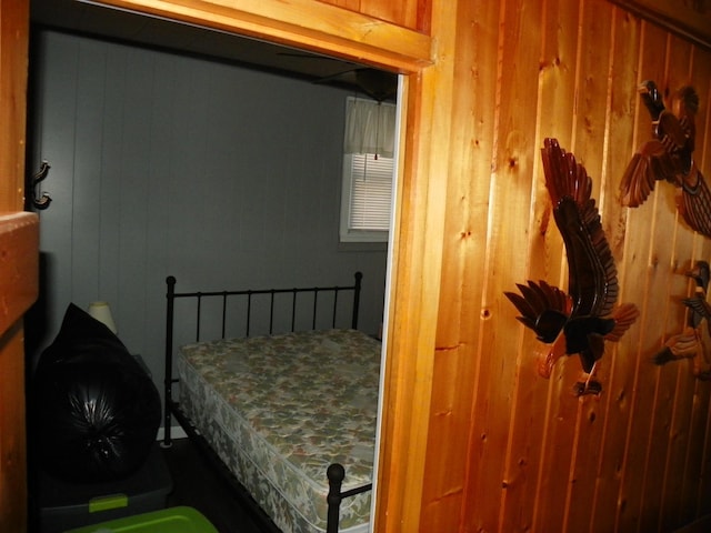 bedroom with wood walls