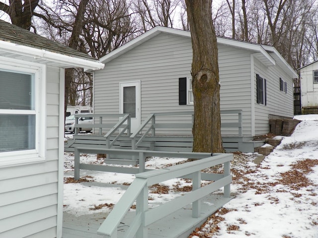 snow covered property featuring a deck