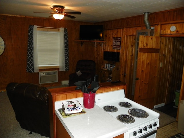 kitchen with ceiling fan, white electric stove, and wood walls