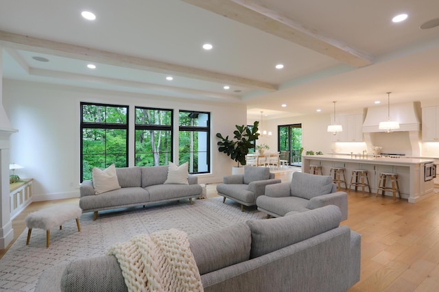 living room with beam ceiling and light wood-type flooring