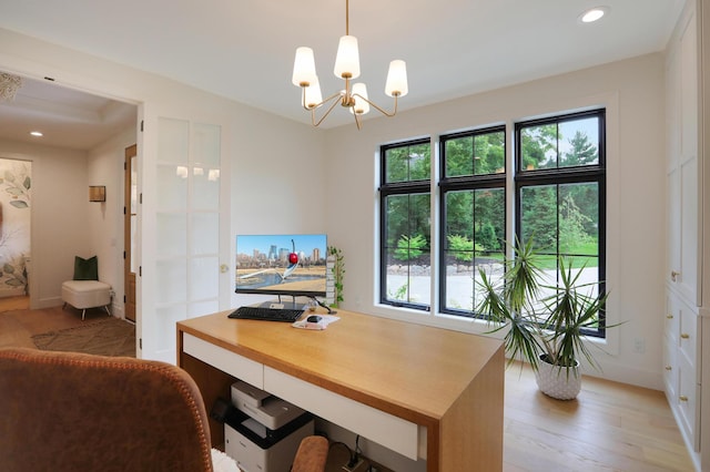 office with an inviting chandelier and light wood-type flooring