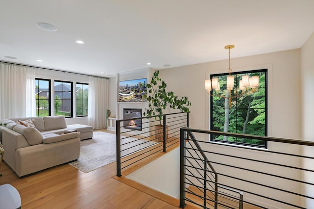 living room with a notable chandelier and light wood-type flooring