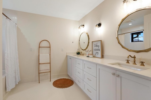 bathroom featuring vanity and shower / bathtub combination with curtain