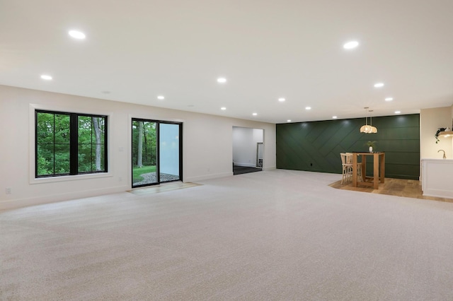 unfurnished living room with light colored carpet