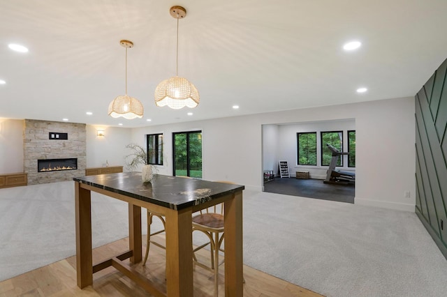 carpeted dining space with a fireplace