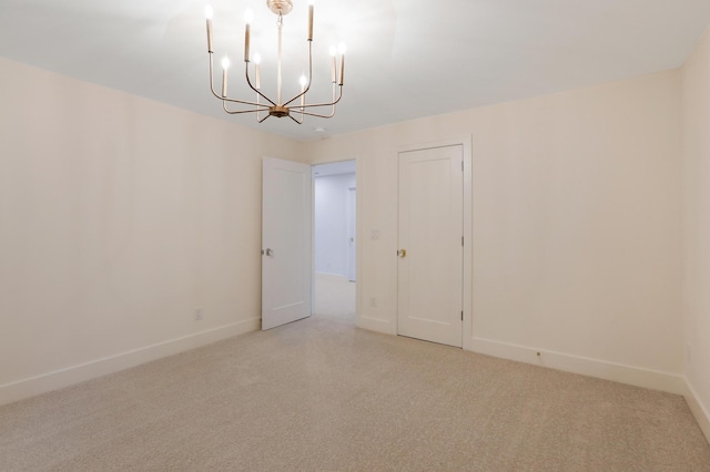 unfurnished room with an inviting chandelier