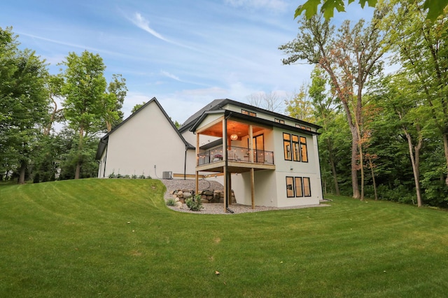 rear view of house with a lawn and central air condition unit