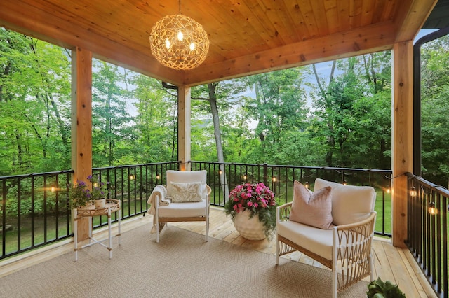 sunroom with a notable chandelier and wooden ceiling