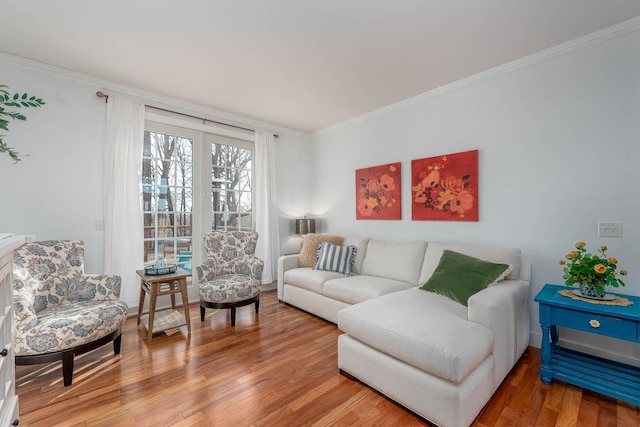 living room with wood-type flooring and ornamental molding