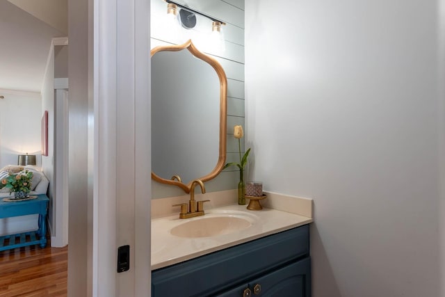 bathroom with hardwood / wood-style flooring and vanity