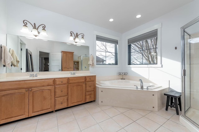 bathroom featuring vanity, shower with separate bathtub, and tile patterned floors