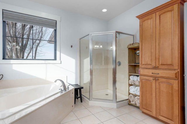 bathroom with separate shower and tub and tile patterned flooring