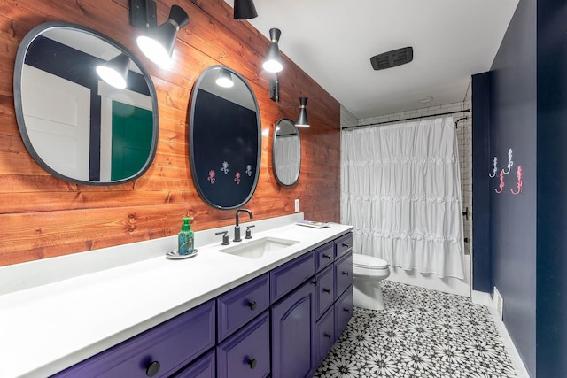 full bathroom with vanity, toilet, shower / tub combo, and wood walls