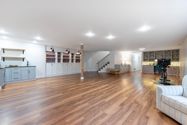 living room with sink and light wood-type flooring